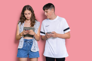 adolescentes usando el teléfono móvil antes de empezar un examen